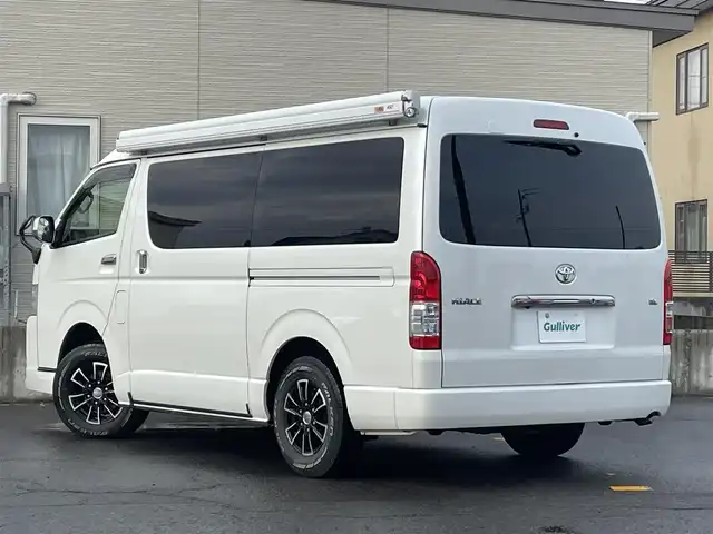 トヨタ ハイエース GL 青森県 2018(平30)年 9.5万km ホワイトパールクリスタルシャイン 4WD/ワンオーナー/モデリスタエアロ　/キャンピング仕様/ベッドキッド/タープ/シンク/フローリング/後席回転対座シート/後席TVモニター有（HDMI用）/WAC/片側パワースライドドア/社外ナビ/・フルセグ/AM/FM/CD/DVD/BT/純正フロアマット/センターコンソール/車線逸脱警報/横滑り防止機能/ヒルスタートアシスト/UVカットガラス/プライバシーガラス/盗難防止装置/オートライト/ETC/スペアキー/純正スターター/保証書/取扱説明書