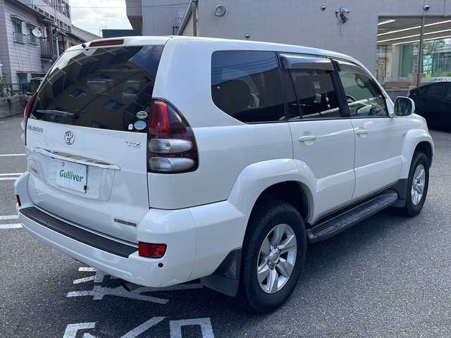 トヨタ ランドクルーザー プラド TZ Gセレクション 広島県 2006(平18)年 15.5万km ホワイトパールクリスタルシャイン /登録時走行距離/　　　　　　　154472キロ/ワンオーナー/メーカーナビ/バックカメラ/ベージュ革シート/シートヒーター/COOL BOX/スペアキー×１/ETC/新車時整備手帳/　　【保証書】/取扱説明書/