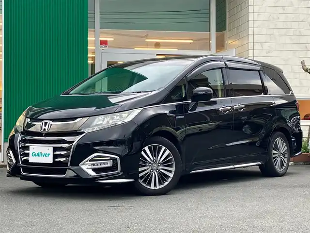 ホンダ オデッセイ ハイブリッド アブソルート・EXホンダセンジング 静岡県 2019(平31)年 8.9万km クリスタルブラックパール エンジンスタートボタン/パワーステアリング/パワーウィンドウ/アイドリングストップ/スマートキー/スペアキー１本/Wオートエアコン/レーダークルーズコントロール/後席モニター/ETC2.0/USB入力端子/全方位カメラ/純正ナビ(CD/DVD/BT/フルセグ)/ドライブレコーダー前後/ウォークスルー/純正フロアマット/D席N席パワーシート/D席N席シートヒーター/両側パワースライドドア/純正アルミホイール/ABS/横滑り防止装置/コーナーセンサー前後/レーンキープアシスト/オートライト/LEDヘッドライト/W+サイドエアバッグ/カーテンエアバッグ/衝突軽減システム/HDMI/BSM/デジタルインナーミラー