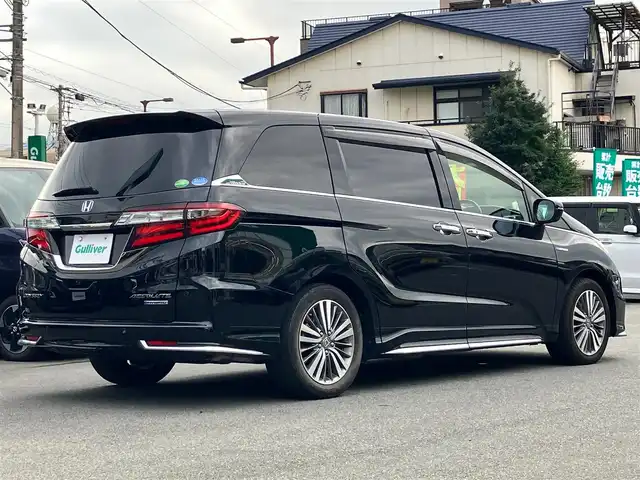 ホンダ オデッセイ ハイブリッド アブソルート・EXホンダセンジング 静岡県 2019(平31)年 8.9万km クリスタルブラックパール エンジンスタートボタン/パワーステアリング/パワーウィンドウ/アイドリングストップ/スマートキー/スペアキー１本/Wオートエアコン/レーダークルーズコントロール/後席モニター/ETC2.0/USB入力端子/全方位カメラ/純正ナビ(CD/DVD/BT/フルセグ)/ドライブレコーダー前後/ウォークスルー/純正フロアマット/D席N席パワーシート/D席N席シートヒーター/両側パワースライドドア/純正アルミホイール/ABS/横滑り防止装置/コーナーセンサー前後/レーンキープアシスト/オートライト/LEDヘッドライト/W+サイドエアバッグ/カーテンエアバッグ/衝突軽減システム/HDMI/BSM/デジタルインナーミラー