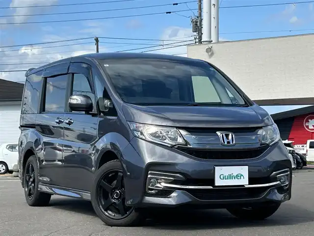 ホンダ ステップワゴン スパーダ ホンダセンシング 道東・釧路十勝 2017(平29)年 9.9万km モダンスティールM 4WD/寒冷地仕様/Honda SENSING/・衝突軽減ブレーキ/・アクティブ　クルーズコントロール/・路外逸脱抑制機能/・誤発進抑制機能/・先行車発進お知らせ機能/・標識認識機能/社外SDナビ/（CD/DVD/BT）/フルセグTV/バックカメラ/後席用フリップダウンモニター/両側パワースライドドア/社外AW夏タイヤ/純正AW冬タイヤ積込/トリプルゾーンフルオートエアコン/スマートキー/スペアキー/社外エンジンスターター/パドルシフト/ステアリングスイッチ/革巻きステアリング/ビルトインETC/前後ドライブレコーダー/シートヒーター/プッシュスタート/わくわくリアゲート/LEDヘッドライト/フォグランプ/取扱説明書/保証書/記録簿
