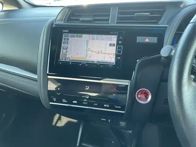 ホンダ フィット ハイブリット S ホンダセンシング 鳥取県 2018(平30)年 5.7万km プレミアムホワイトパールⅡ 純正ナビ／ＴＶ／ＤＶＤ／ＣＤ／ＢＴ/バックカメラ/ビルトインＥＴＣ/ドライブレコーダー/ホンダセンシング/レーダークルーズコントロール/レーンアシスト/パドルシフト/ＬＥＤヘットライト/フォグライト/純正エアロパーツ/リヤルーフスポイラー/純正１６インチアルミホイール/プッシュエンジンスタート/アイドリングストップ/フロアマット/ドアバイザー