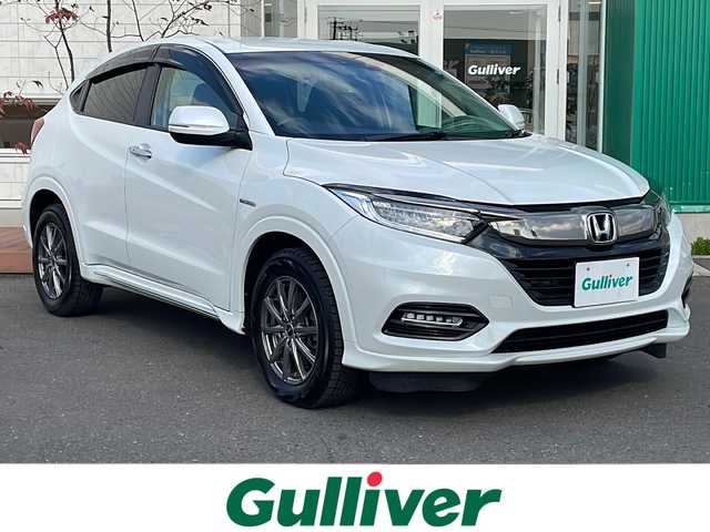 ホンダ ヴェゼル ハイブリッド Z ホンダセンシング 青森県 2021(令3)年 6.9万km プラチナホワイトパール 4WD/寒冷地仕様/純正8インチSDナビ・フルセグ/CD・DVD・Bluetooth・SD/バックカメラ/ハーフレザーシート/前席シートヒーター/純正エンジンスターター/純正前後ドライブレコーダー/衝突軽減ブレーキ/追従クルーズコントロール/レーンキープアシスト/ワイパーデアイサー/ビルトインETC/LEDヘッドライト/LEDフォグランプ/社外16インチアルミ/純正17インチアルミあり/スペアキー/保証書・取説書