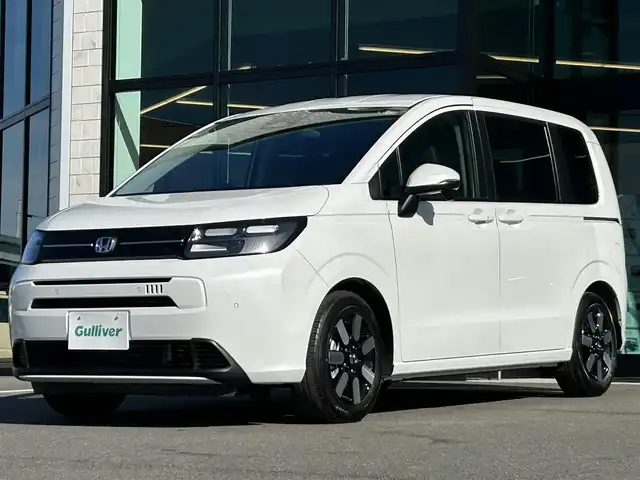 ホンダ フリード ハイブリット e:HEV AIR EX 愛媛県 2025(令7)年 0.1千km プラチナホワイトパール 純正ナビ（Bluetooth/フルセグTV）/アダプティブクルーズコントロール/バックカメラ/AppleCarPlay/AndroidAuto/3列シート/ウォークスルー/両側パワースライドドア/純正15インチアルミホイール/ホンダセンシング/ブラインドスポットモニター/ステアリングリモコン/前後コーナーセンサー/LEDヘッドライト/スマートキー