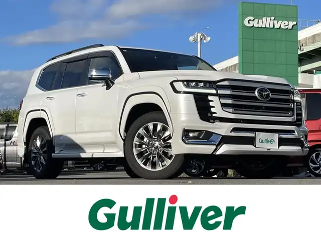 トヨタ ランドクルーザー 愛知県 2024(令6)年 0.7万km プレシャスホワイトパール メーカー純正ナビ　/サンルーフ　/本革レザーシート　/Ｆ・Ｒモデリスタエアロ　/スポーツマフラー　/パワーバックドア　/クリアランスソナー　/リアエンターテイメント　/純正２０インチＡＷ　/ＥＴＣ２．０/純正フロアマット・ドアバイザー/パワーバックドア/BT/DTV/ルーフレール/衝突軽減ブレーキシステム