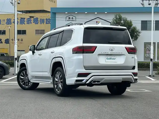 トヨタ ランドクルーザー ZX 愛媛県 2024(令6)年 0.1万km プレシャスホワイトパール メーカーオプション純正ナビ/BT/AM・FM/フルセグTV/JBLサウンド/リヤエンターテインメントシステム/ビルトインETC2.0/前後ドライブレコーダー/全方位カメラ/モデリスタエアロパーツ/サンルーフ/ルーフレール/本革シート/前席パワーシート/全席シートヒーター・クーラー/D席シートメモリー/ステアリングヒーター/オートライト/オートマチックハイビーム/追従型クルーズコントロール/ブラインドスポットモニター/ヘッドアップディスプレイ/4WD/ダウンヒルアシストコントロール/センターデフロック/純正アルミホイール/純正アルミホイール