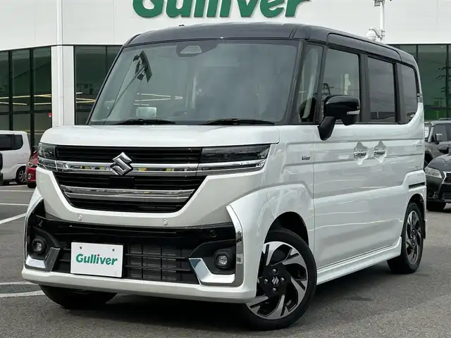 スズキ スペーシア カスタム HYBRID XS 愛媛県 2023(令5)年 0.1千km ピュアホワイトパール/ブラック2トーン 登録時走行距離：8Km/横滑り防止装置/衝突軽減システム/レーンキープアシスト/パーキングアシスト/アイドリングストップ/エンジンスタートボタン/追従クルコン/ＡＢS/LEDヘッドライト/オートライト/両側パワスラ/スマートキー/ハンドルヒーター/シートヒーター/純正アルミホイール