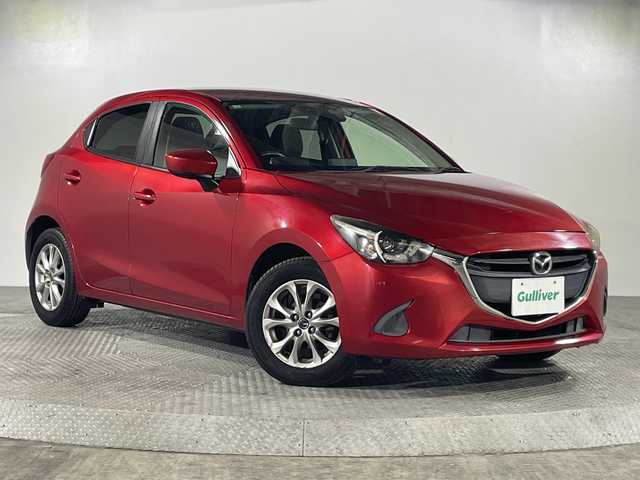 マツダ デミオ 13S 沖縄県 2015(平27)年 14.1万km ソウルレッドプレミアムメタリック 「禁煙車/ワンオーナー/純正ディスプレイオーディオ/Ｂｌｕｅｔｏｏｔｈ/バックカメラ/ＬＥＤヘッドライト/アイドリングストップ/オートライト/電動格納ミラー/横滑り防止装置/スペアキー/取扱説明書/保証書