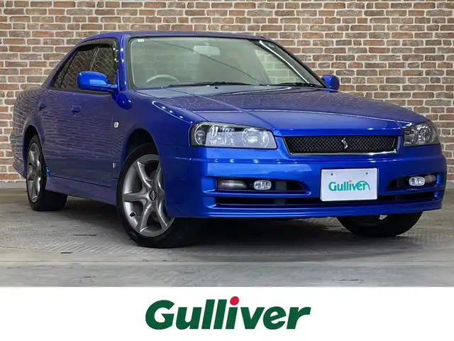 日産 スカイライン 25GT－V 岩手県 2000(平12)年 7.7万km ベイサイドブルー 後期型/フルノーマル車/５速マニュアルミッション/RE25DE/電動スーパーHICAS/４輪ブレーキキャリパー対向ピストンブレーキ/ヘリカルLSD/リヤスタビライザー/純正キセノンランプ/純正フォグランプ/オートエアコン/ETC/純正ナビ/純正17インチアルミホイールガンメタカラー