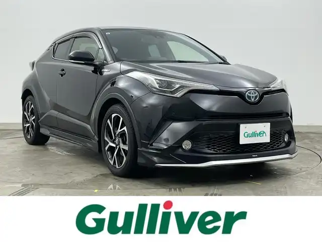 トヨタ Ｃ－ＨＲ ハイブリッド 1．8G 熊本県 2017(平29)年 6.5万km ブラックマイカ モデリスタエアロ【前・横・後】/純正9インチSDナビ（NSZT-Y66T）/【CD/DVD/BT/フルセグ】　/レーダークルーズコントロール　/シートヒーター前席　/ＥＴＣ　/バックカメラ　/ドライブレコーダー/ブラインドスポットモニター/コーナーセンサー前後/スペアキー×1/LEDヘッドライト/オートライト/オートハイビーム/オートブレーキホールド/ISOFIX/ステアリングスイッチ/ドアバイザー/アイドリングストップ/新車保証書/取扱説明書/スペアキー×1