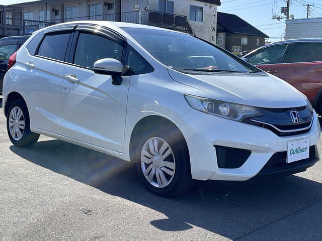 ホンダ フィット 13G Lパッケージ 道東・釧路十勝 2015(平27)年 6.5万km プレミアムホワイトパール 4WD/寒冷地仕様/純正メモリナビ　VXM-145VSi/　(AM/FM/CD/DVD/BT)/バックカメラ/アイドリングストップ/社外ETC/ステアリングスイッチ/スマートキー/LEDヘッドライト