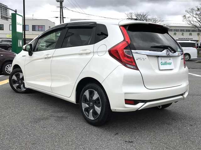 ホンダ フィット ハイブリット L ホンダセンシング 鳥取県 2018(平30)年 5.7万km プレミアムホワイトパールⅡ 純正ナビ/フルセグ/CD/DVD/BT/バックカメラ・ETC/ホンダセンシング/レーンキープアシスト/レーダークルーズコントロール/ハーフレザーシート/LEDヘットライト/フォグライト/ステアリングスイッチ/プッシュエンジンスタート/スマートキー/フロアマット/ドアバイザー