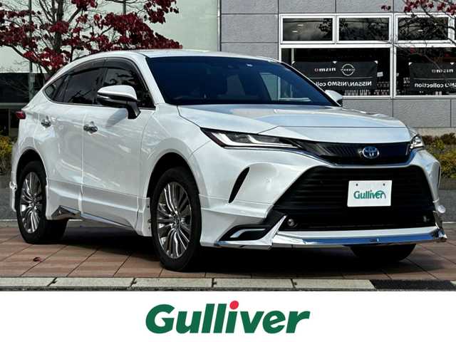 トヨタ ハリアー ハイブリッド Z レザーパッケージ 福島県 2023(令5)年 2.2万km プラチナホワイトパールマイカ トヨタセーフティセンス/プリクラッシュセーフティ/レーントレーシングアシスト/レーダークルーズコントロール/レーンディパーチャーアラート/オートマチックハイビーム/ロードサインアシスト/ドライバー異常時対応システム/プロアクティブドライビングアシスト /モデリスタエアロ/純正ディスプレイオーディオ/【USB/BT/TV/Miracast/ナビ機能】/バックカメラ/ビルトインETC/デジタルインナーミラー/ブラインドスポットモニター/ヘッドアップディスプレイ/ステアリングヒーター/前席シートヒーター/前席ベンチレーション/前席パワーシート/パワーバックドア/LEDオートライト/LEDフォグランプ/純正フロアマット/純正ドアバイザー