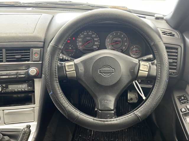 日産 スカイライン 25GT ターボ 沖縄県 1998(平10)年 14.5万km 白 5速MT/純正オーディオ(DH-700)/CD/ヘッドライトレベライザー /パワーステアリング/パワーウィンドウ/電格ミラー/リモコンキー/社外アルミ(RS-5)/柿本 Regu 92-Z マフラー