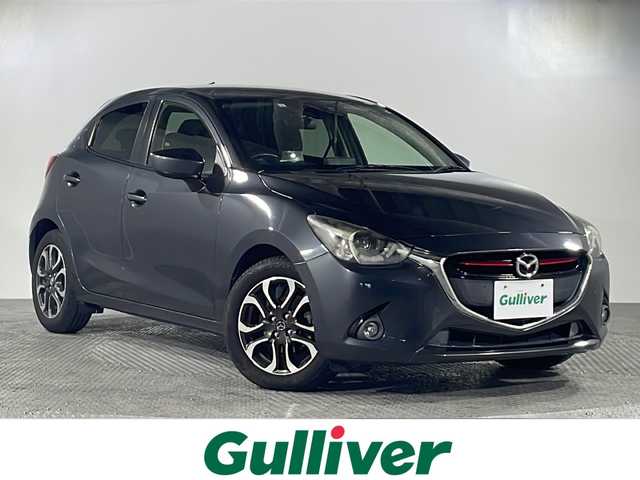 マツダ デミオ XD ツーリング 沖縄県 2015(平27)年 9万km メテオグレーマイカ 県外仕入/禁煙車/純正ナビ/ CD/DVD/Bluetooth/フルセグTV/スマートシティブレーキ/ヘッドアップディスプレイ/クルーズコントロール/ETC/ステアリングスイッチ/パドルシフト/ターボ/スペアキー/純正アルミホイール