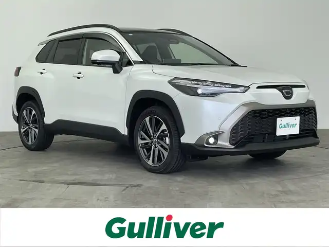 トヨタ カローラ クロス ハイブリッド Z 大分県 2024(令6)年 0.1万km プラチナホワイトパールマイカ トヨタセーフティセンス/・プリクラッシュセーフティ/・レーントレーシングアシスト/・オートマチックハイビーム/・レーダークルーズコントロール/純正ディスプレイオーディオ/（BT/フルセグTV/AppleCarPlay/パノラミックビューモニター/パノラマルーフ/パワーバックドア/LEDオートライト/フォグランプ/ハーフレザーシート/パワーシート/シートヒーター/純正18インチアルミホイール/クリアランスソナー/スマートキー/ETC2.0/保証書