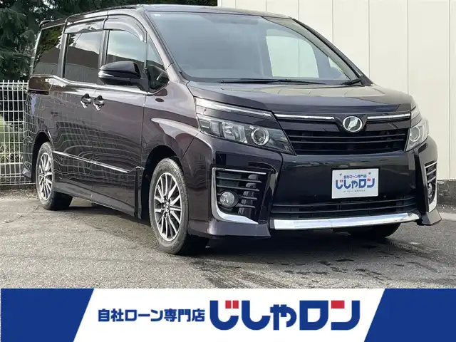 トヨタ ヴォクシー ZS 福島県 2014(平26)年 13.4万km ボルドーマイカメタリック (株)IDOMが運営する【じしゃロン福島店】の自社ローン専用車両になります。こちらは現金またはオートローンご利用時の価格です。自社ローンご希望の方は別途その旨お申付け下さい/純正SDナビ/ETC/片側パワースライドドア/プッシュスタート/アイドリングストップ/ドアバイザー/革巻きステアリング/ステアリングリモコン/ECOモード/フリップダウンモニター/禁煙車