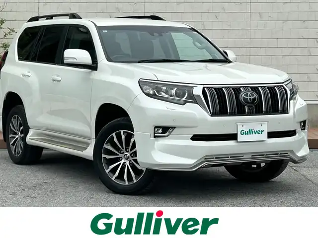 トヨタ ランドクルーザー プラド TX Lパッケージ 滋賀県 2018(平30)年 5万km ホワイトパールクリスタルシャイン ディーゼル/4WD(F4)/6速AT/純正ナビ【B9129】/（フルセグ/AM/FM/CD/DVD/Bluetooth/USB/SD）/プリクラッシュブレーキアシスト	/ブレーキアシスト	/ヒルスタート（坂道発進）アシスト	/ブラインドスポットモニター/レーンキープアシスト	/バックカメラ前/後/360°カメラ（フロント/サイド/バック）/ETC/レーダークルーズ/オートハイビーム/フロント・リアエアロ/ヘッドライトウォッシャー/前後コーナーセンサー/センターデフフロック/シートヒーターD/N席/ベンチレーションD/N席/MTモード付AT/D/N席パワーシート/電動格納サードシート/19インチ純正AW/ウッドコンビステアリング/テレビキャンセラー/横滑り防止/純正エンジンスターター/USBポート/純正マット/プッシュスタート/ウィンカーミラー/電動格納ミラー