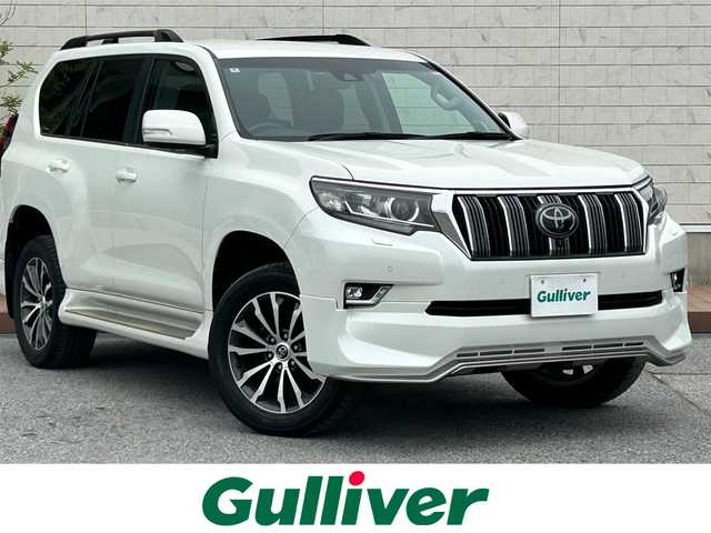 トヨタ ランドクルーザー プラド TX Lパッケージ 滋賀県 2018(平30)年 5万km ホワイトパールクリスタルシャイン ディーゼル/4WD(F4)/6速AT/純正ナビ【B9129】/（フルセグ/AM/FM/CD/DVD/Bluetooth/USB/SD）/プリクラッシュブレーキアシスト	/ブレーキアシスト	/ヒルスタート（坂道発進）アシスト	/ブラインドスポットモニター/レーンキープアシスト	/バックカメラ前/後/360°カメラ（フロント/サイド/バック）/ETC/レーダークルーズ/オートハイビーム/フロント・リアエアロ/ヘッドライトウォッシャー/前後コーナーセンサー/センターデフフロック/シートヒーターD/N席/ベンチレーションD/N席/MTモード付AT/D/N席パワーシート/電動格納サードシート/19インチ純正AW/ウッドコンビステアリング/テレビキャンセラー/横滑り防止/純正エンジンスターター/USBポート/純正マット/プッシュスタート/ウィンカーミラー/電動格納ミラー
