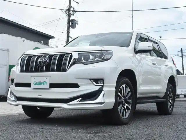 トヨタ ランドクルーザー プラド TX Lパッケージ 神奈川県 2023(令5)年 1万km ホワイトパールクリスタルシャイン ワンオーナー/モデリスタエアロ/純正メモリナビ/フルセグテレビ/全方位カメラ/サンルーフ/レザーシート/エアーシート/シートヒーター/クルーズコントロール/ETC2.0/LEDヘッドライト/保証書/取説/ナビ説/記録(R.6)/スペアスマートキー