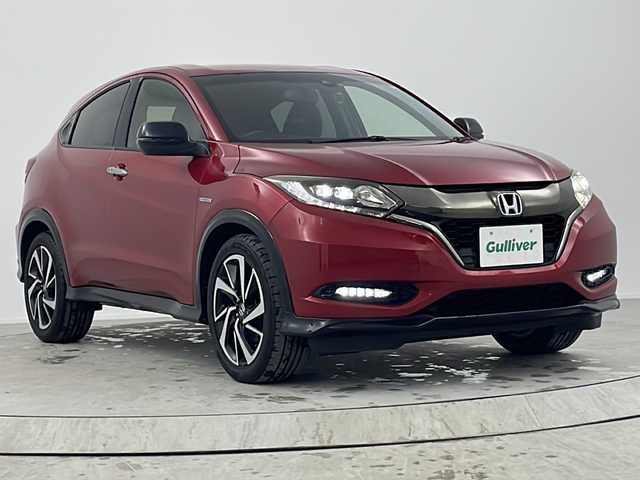 ホンダ ヴェゼル ハイブリッド RS ホンダセンシング 熊本県 2017(平29)年 7万km プレミアムクリスタルレッドM 【 Honda SENSING 】/・衝突軽減ブレーキ 〈CMBS〉/・歩行者事故低減ステアリング/・ACC 〈アダプティブ・クルーズ・コントロール〉/・LKAS 〈車線維持支援システム〉/・路外逸脱抑制機能/・誤発進抑制機能/・先行車発進お知らせ機能/・標識認識機能/ワンオーナー/純正メモリーナビ/フルセグテレビ/バックカメラ/Bluetooth/DVD再生可能/ハーフレザーシート/社外ドライブレコーダー（フロント）/オートライト/ＬＥＤヘッドライト/ビルトインETC/スマートキー3個/純正フロアマット/純正18ＡＷ/D・N席シートヒーター