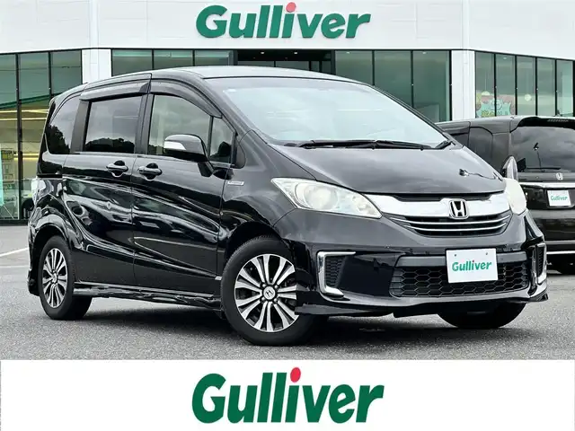 ホンダ フリード ハイブリット ジャストセレクション 島根県 2014(平26)年 7.4万km プレミアムスパークルブラックパール 登録時走行距離73/789Km/両側パワースライドドア/クルーズコントロール/純正メモリナビ【VXM-155VSi】/(DVD/ワンセグTV/Bluetooth)/ステアリングスイッチ/バックカメラ/ビルトインETC/前方ドライブレコーダー/横滑り防止機能/スマートキー/HIDヘッドライト/ウィンカーミラー/スタッドレスタイヤ積込/新車時保証書/取扱説明書