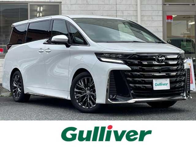 トヨタ ヴェルファイア Z プレミア 福岡県 2024(令6)年 1万km プラチナホワイトパールマイカ ワンオーナー/ムーンルーフ/純正13.2型後席モニター【V13T-R72F】/純正14型ディスプレイオーディオ/　(Bluetooth/ナビ・TVキット)/パノラミックビューモニター/バックカメラ/ユニバーサルステップ(両側)/デジタルインナーミラー/トヨタセーフティセンス/・アドバンストパーク/・レーダークルーズコントロール/・プリクラッシュセーフティ/・レーンディパーチャーアラート/・レーンチェンジアシスト/・ロードサインアシスト/・プロアクティブドライビングアシスト/・フロント、リヤクロストラフィックアラート/・オートマッチックハイビーム/ブラインドスポットモニター/安心降車アシスト/周辺車両、後方車両接近告知/パーキングサポートブレーキ/クリアランスソナー/リヤカメラディテクション/純正19インチAW/両側パワースライドドア/パワーバックドア/ヘッドアップディスプレイ/パドルシフト/黒色レザーシート/パワーシート/シートヒーター/ベンチレーション/(D席N席2列目)/D席シートメモリー/置くだけ充電/ビルトインETC2.0/USBタイプC端子/100V電源/スペアキー×1