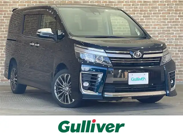 トヨタ ヴォクシー ZS 煌Ⅱ 岩手県 2017(平29)年 8万km ブラッキッシュアゲハガラスフレーク 4WD/ロールサンシェード/後席モニター/衝突被害軽減システム/両側パワースライドドア/MTモード付きAT/寒冷地仕様/アイドリングストップ/横滑り防止装置/ETC/バックカメラ/フルセグTV/レーンアシスト/純正LEDヘッドライト/社外ナビ/社外マット/オートライト/オートマチックハイビーム/エンジンスターター