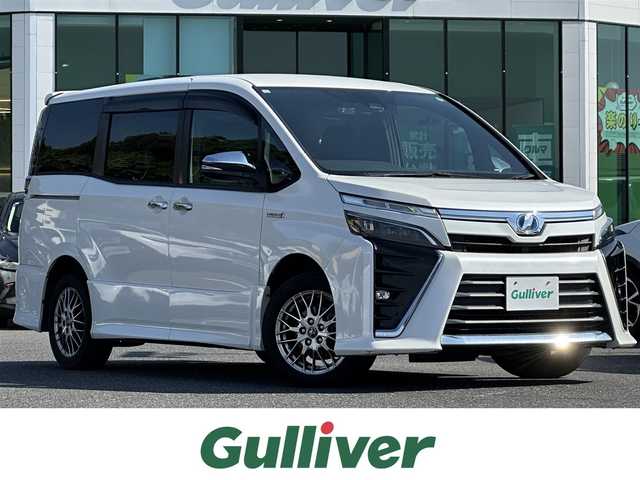 トヨタ ヴォクシー ハイブリッド ZS 煌 島根県 2017(平29)年 10.6万km ホワイトパールクリスタルシャイン トヨタセーフティセンス/アルパイン11インチナビ/CD/DVD/DTV/Bluetooth/バックカメラ/両側パワースライドドア /クルーズコントロール/シートヒーター /LEDオートライト/オートマチックハイビーム /LDA/ステアリングスイッチ/ドライブレコーダー/ビルトインETC/スマートキー/プッシュスタート /純正フロアマット/純正ドアバイザー