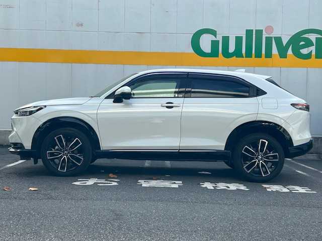 ホンダ ヴェゼル ハイブリッド e:HEV Z 東京都 2022(令4)年 3.7万km プラチナホワイトパール ９インチメモリナビ/フルセグテレビ/ETC2.0/マルチビューカメラシステム/ブラインドスポットインフォメーション/追従型クルーズコントロール/パワーバックドア/前後コーナーセンサー/本革巻きステアリング/ステアリングヒーター/プリクラッシュセーフティ/パドルシフト/パワーバックドア/ハーフレーザーシート/シートヒーター（D＋N席）/横滑り防止装置/ダウンヒルアシストコントロール/プッシュスタート/純正アルミホイール/純正フロアマット