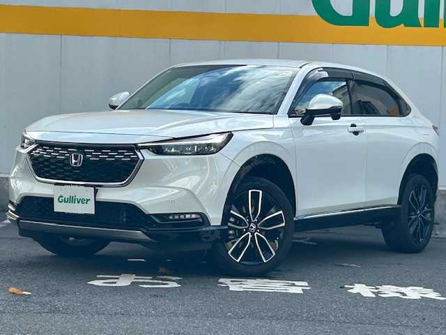ホンダ ヴェゼル ハイブリッド e:HEV Z 東京都 2022(令4)年 3.7万km プラチナホワイトパール ９インチメモリナビ/フルセグテレビ/ETC2.0/マルチビューカメラシステム/ブラインドスポットインフォメーション/追従型クルーズコントロール/パワーバックドア/前後コーナーセンサー/本革巻きステアリング/ステアリングヒーター/プリクラッシュセーフティ/パドルシフト/パワーバックドア/ハーフレーザーシート/シートヒーター（D＋N席）/横滑り防止装置/ダウンヒルアシストコントロール/プッシュスタート/純正アルミホイール/純正フロアマット
