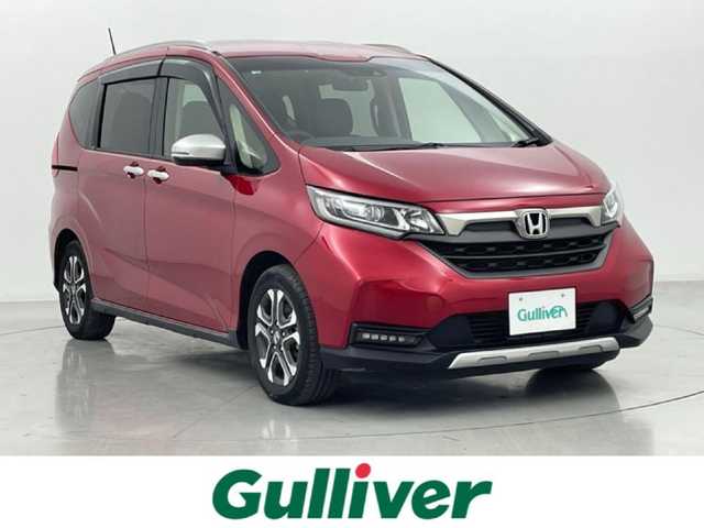ホンダ フリード ハイブリット クロスター 熊本県 2022(令4)年 4.8万km プレミアムクリスタルレッドM 純正前後ドライブレコーダー　/純正フリップダウンモニター/純正9インチナビ（ＣＤ・ＤＶＤ・フルセグ・ＢＴ・ＳＤ・ApplCarPlay）/バックカメラ　/ビルトインＥＴＣ　/両側パワースライドドア　/後ろのみクリアランスソナー　/前席シートヒーター　/レーダークルーズコントロール/衝突軽減ブレーキ/先行車発進お知らせ機能/路外逸脱制御機能/標識認識機能/ハーフレザーシート/純正フロアマット/純正１５インチAW/オートライト/LEDヘッドライト/フォグランプ/スマートキー/プッシュスタート/スペアキー1本