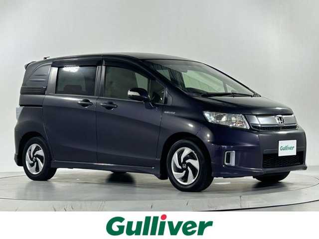 ホンダ フリード スパイク ハイブリット プレミアムエディション 佐賀県 2016(平28)年 1万km グラマラスモーブP 純正７インチナビ【VXM-165VFi】/（フルセグTV/BT/CD/SD）/純正フリップダウンモニター/バックカメラ/両側パワースライドドア/ビルトインETC/クルーズコントロール/運転席パワーシート/オートライト/横滑り防止装置/純正フロアマット