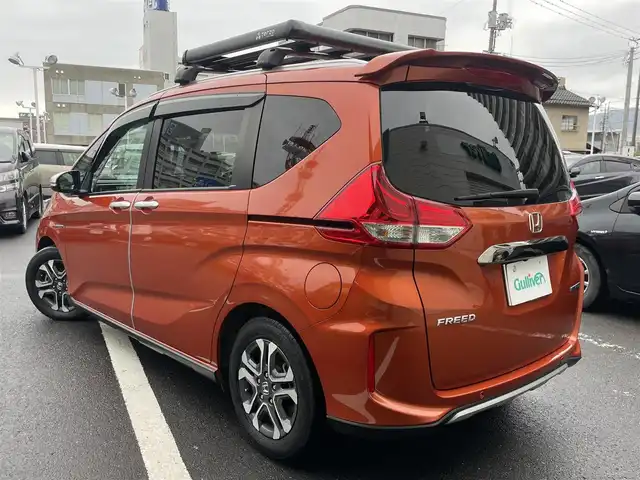 ホンダ フリード ハイブリット クロスター ホンダセンシング 島根県 2021(令3)年 3.6万km プレミアムクリスタルオレンジM 純正メモリナビ　/(フルセグTV/ＤＶＤ再生/Ｂｌｕｅｔｏｏｔｈ接続)　/前後ドライブレコーダー　/バックカメラ　/ビルトインＥＴＣ　/両側パワースライドドア　/前席シートヒーター/渋滞追従機能付アダプティブ・クルーズ・コントロール/リアコーナーセンサー　/レーンアシスト/衝突軽減ブレーキ/　オートハイビーム／ライト　/純正ＬＥＤヘッドライト/純正15インチアルミホイール/純正フロアマット/スマートキー1本