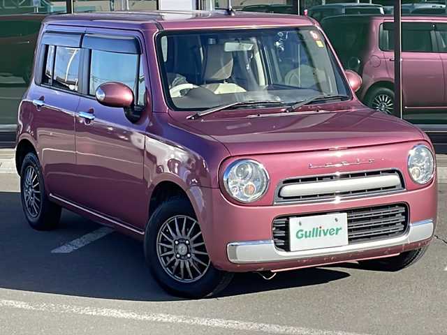 スズキ ラパン ショコラ X 道東・釧路十勝 2014(平26)年 10.9万km カシスピンクパールメタリック ・4WD/・社外SDナビ/（ラジオ CD ワンセグ USB）/・バックカメラ/・社外エンジンスターター/・HIDヘッドライト/・オートライト/・ヘッドライトレベライザー/・革巻きステアリング/・運転席のみシートヒーター/・アイドリングストップ/・電格ウィンカーミラー/・ドアバイザー/・スマートキー/・プッシュスタート/・鉄ホイール付夏用タイヤ積込