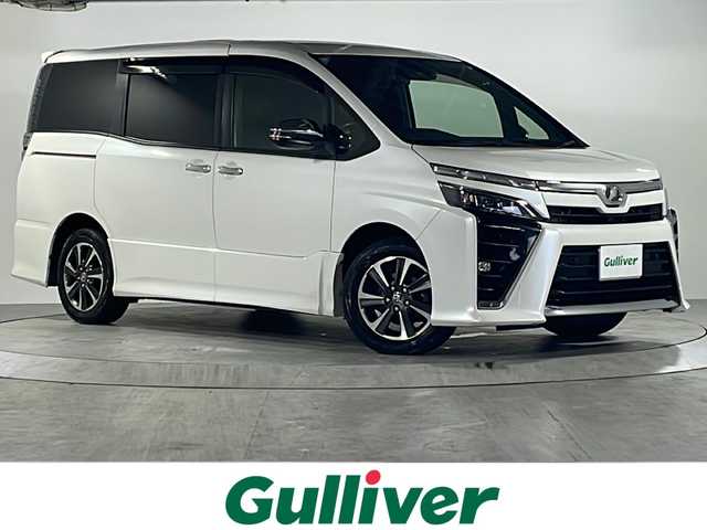 トヨタ ヴォクシー ZS 煌Ⅱ 広島県 2019(令1)年 6.6万km ホワイトパールクリスタルシャイン トヨタセーフティセンス/純正10インチナビ/CD/DVD/Bluetooth/DTV/バックカメラ/純正フリップダウンモニター/両側パワースライドドア/クルーズコントロール/純正アルミホイール/LEDオートライト/オートマチックハイビーム /ビルトインETC/アイドリングストップ/スマートキー/プッシュスタート/フロアマット