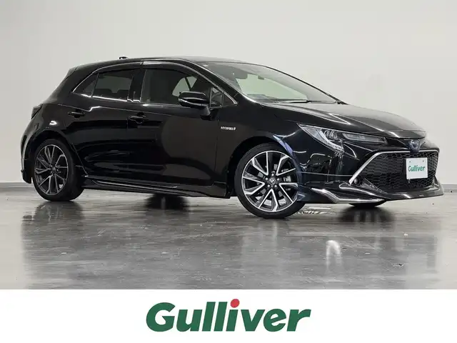 トヨタ カローラ スポーツ ハイブリッドG Z 三重県 2019(平31)年 1.1万km アティチュードブラックマイカ ハイブリッド/FF/フロアCVT/純正 9インチナビ NSZT-Y68T/（AM/FM/CD/DVD/TV/SD/SDREC/Bluetooth）/バックガイドモニター/モデリスタエアロ（F/S/R下）/ビルトインETC/Toyota Safety Sense/●プリクラッシュセーフティ/●レーントレーシングアシスト/●レーダークルコン（全車速追従機能付）/●オートハイビーム/●ロードサインアシスト/・パーキングサポートブレーキ（前後静止物）/・車両接近通報装置/装備/・左右独立温度コントロールフルオートエアコン/・オートライト/・LED ヘッドランプ＆フロントフォグランプ/・電子パーキングブレーキ/・オートブレーキホールド/・ステアリングスイッチ/・プッシュスタート/・純正18inAW/・保/取/ナビ取/・スマートキーx1/など
