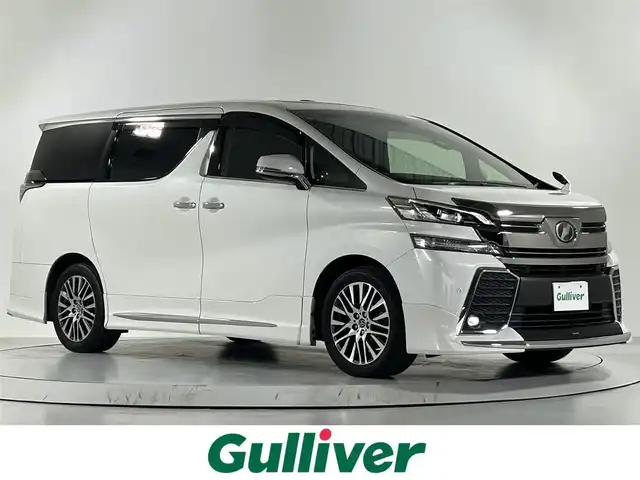 トヨタ ヴェルファイア Z Gエディション 佐賀県 2017(平29)年 8.2万km ホワイトパールクリスタルシャイン 社外アルパイン製11インチナビ【EX11V】/【フルセグTV.CD.DVD.Bluetooth】/社外アルパイン製12.8インチフリップダウンモニター/サンルーフ/モデリスタエアロ/衝突被害軽減システム/バックカメラ/レーダークルーズコントロール/レーンアシスト/オートライト/オートマチックハイビーム/クリアランスソナー/電動パーキング/ブレーキホールド/ステアリングヒーター/ウッドステアリング/パワーバックドア/ビルトインETC/両側パワースライドドア/運転席・助手席パワーシート/ハーフレザーシート/LEDヘッドライト/フォグライト/ISOFIX対応シート/オットマン/スマートキー×１