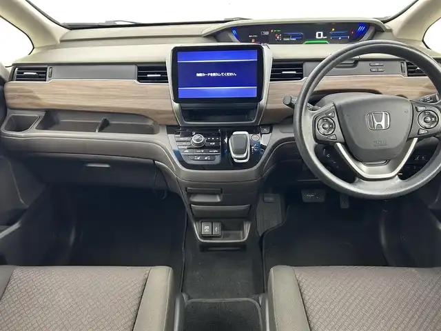 ホンダ フリード ハイブリット G ホンダセンシング 千葉県 2020(令2)年 6.2万km プラチナホワイトパール フリップダウンモニター/ホンダセンシング/・衝突軽減ブレーキ/・先行車発進お知らせ機能/・路外逸脱抑制機能/・レーンキープアシスト/社外9インチフローティングナビ/CD DVD BT フルセグ/バックカメラ/両側パワースライドドア/レーダークルーズコントロール/LEDオートライト/シートヒーター/純正15インチアルミホイール/ステアリングスイッチ/純正フロアマット/プッシュスタート/スマートキー/ETC