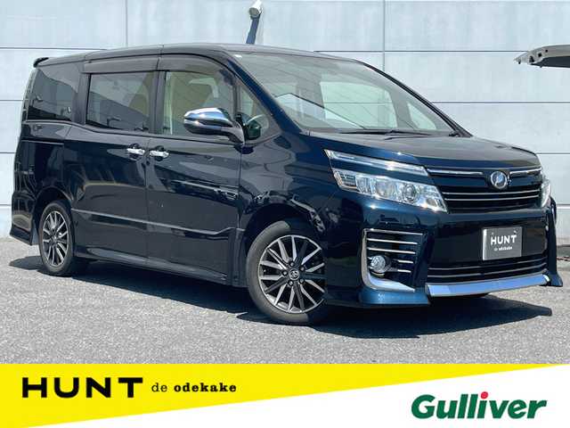 トヨタ ヴォクシー ZS 煌 千葉県 2015(平27)年 6.6万km ブラッキッシュアゲハガラスフレーク 純正メモリナビ/　(AM/FM/CD/DVD/TV/BT)/純正フリップダウンモニター/両側パワースライドドア/ミラー型前後ドラレコ/バックカメラ/LEDヘッドライト/ビルドインETC/純正16インチAW/スマートキー×2/保証書/取扱説明書