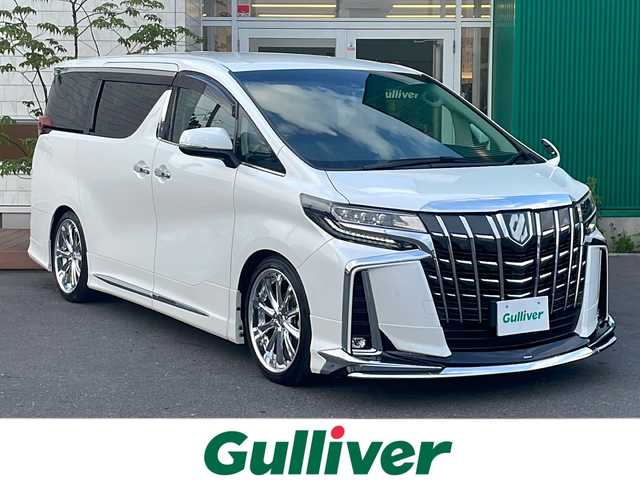 トヨタ アルファードハイブリット SR Cパッケージ 青森県 2021(令3)年 6.9万km ホワイトパールクリスタルシャイン 4WD/純正9インチDAナビ・フルセグTV/純正12.1インチフリップダウンモニター/CD・DVD・Bluetooth・ミラキャスト/黒革シート/前席エアシート・ヒーター/ステアリングヒーター/両側パワースライドドア/パワーバックドア/セーフティセンス/プリクラッシュセーフティ/レーダークルーズコントロール/レーントレーシングアシスト/アダプティブハイビームシステム/パーキングサポートブレーキ/AC100V1500W/ビルトインETC/3眼LEDヘッドランプ/LEDフォグランプ/社外車高調（純正有）/社外20インチアルミ/モデリスタエアロ/スペアキー/保証書・取説書