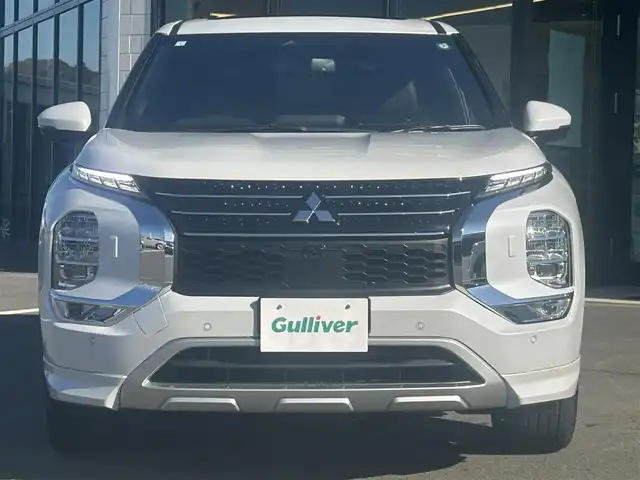 三菱 アウトランダー ＰＨＥＶ P 愛媛県 2024(令6)年 0.4万km ホワイトダイヤモンド 純正ナビ（Bluetooth/AppleCarPlaｙ）/アラウンドビューモニター/ヘッドアップディスプレイ/BOSE製スピーカー/マイパイロット/マッサージ機能（D/N席）/置くだけ充電/全席シートヒーター（サードシート除く)/ステアリングヒーター/シートメモリー/パドルシフト/サンルーフ/パワーシート/純正20インチアルミホイール/純正フロアマット/前後コーナーセンサー/ダウンヒルアシストコントロール/LEDヘッドライト/スマートキー×２