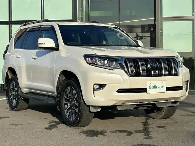 トヨタ ランドクルーザー プラド TX Lパッケージ 愛媛県 2023(令5)年 3.9万km ホワイトパールクリスタルシャイン ワンオーナー/純正ナビ（Bluetooth/フルセグTV）/アラウンドビューモニター/デジタルインナーミラー/TRDプッシュスタートボタン/電動格納サードシート/ETC2.0/電子インナーミラー型ドライブレコーダー/パワーシート/シートヒーター/シートベンチレーション/サンルーフ/アダプティブクルーズコントロール/スペアキー（スマートキー）/純正フロアマット/純正19インチアルミホイール/ルーフレール/センターデフロック/ダウンヒルアシストコントロール/LEDヘッドライト/フォグランプ/スペアタイヤ/保証書/取扱説明書/ナビ取説