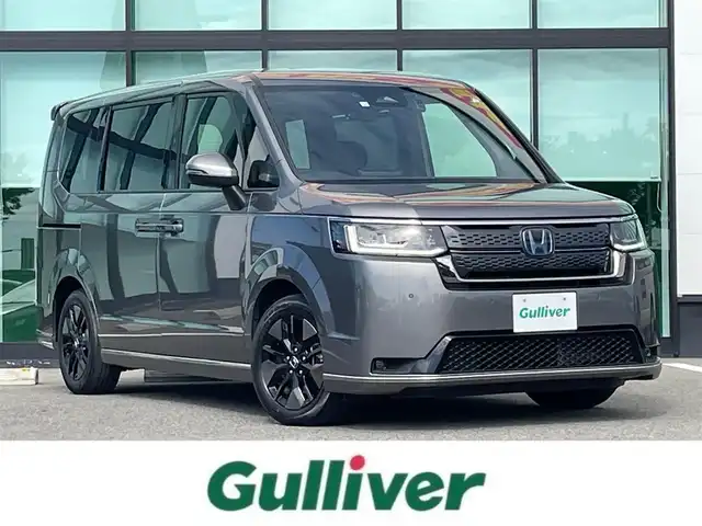 ホンダ ステップワゴン スパーダ eHEV 和歌山県 2022(令4)年 2.7万km スーパープラチナグレーメタリック 純正9インチナビ/バックカメラ/フルセグTV/BT/衝突軽減ブレーキ/前後コーナーセンサー/レーダークルコン/ブラインドスポットモニター/オートライト/レーンキープアシスト/ドラレコ/ビルトインETC/両側パワスラ/シートヒーター/電動リアゲート/オットマン/オートホールド/パドルシフト/LEＤヘッドライト/フォグランプ