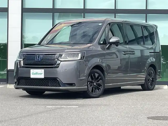 ホンダ ステップワゴン スパーダ eHEV 和歌山県 2022(令4)年 2.7万km スーパープラチナグレーメタリック 純正9インチナビ/バックカメラ/フルセグTV/BT/衝突軽減ブレーキ/前後コーナーセンサー/レーダークルコン/ブラインドスポットモニター/オートライト/レーンキープアシスト/ドラレコ/ビルトインETC/両側パワスラ/シートヒーター/電動リアゲート/オットマン/オートホールド/パドルシフト/LEＤヘッドライト/フォグランプ