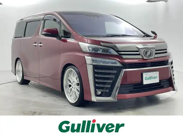 トヨタ ヴェルファイア Z Aエディション 福井県 2018(平30)年 5.8万km ダークレッドマイカメタリック サンルーフ/アルパインナビ/【AM/FM/CD/DVD/Bluetooth/フルセグTV】/アルパインフリップダウンモニター/バックカメラ/ETC/衝突軽減ブレーキ/車線逸脱警報機能/クルーズコントロール（追従有）/オートライト/オートハイビーム/LEDヘッドライド/LEDフォグライド/プッシュスタート/スマートキー/電動サイドブレーキ/ブレーキホールド機能/シートカバー/社外21インチアルミホイール/（純正ホイール車載）/社外マフラー/（純正マフラー車載）