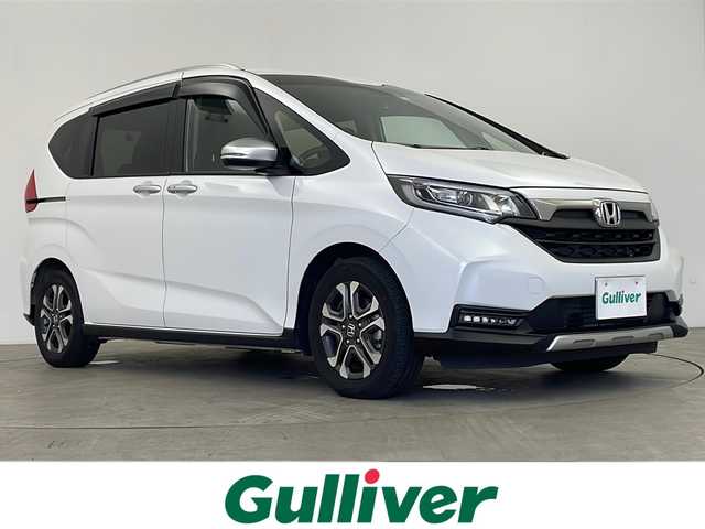 ホンダ フリード ハイブリット クロスター 鹿児島県 2023(令5)年 1.5万km プラチナホワイトパール 純正8型ナビ/(CD/DVD/TV/Bluetooth)/フルセグTV/プッシュスタート/スマートキー/レーダークルーズコントロール/ETC/バックカメラ/純正フロアマット/シートヒーター/両側パワースライドドア/純正アルミホイール/オートライト/LEDヘッドライト/フォグライト/衝突軽減ブレーキ/車線逸脱防止/寒冷地仕様/前後ドライブレコーダー/電動格納ミラー/禁煙車