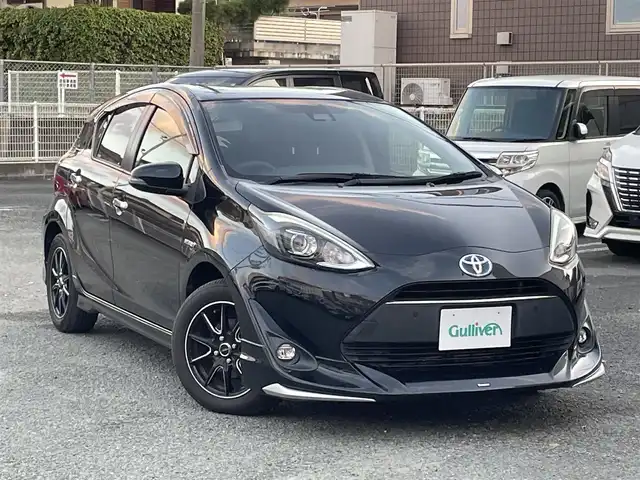 トヨタ アクア S スタイルブラック 熊本県 2018(平30)年 7.6万km ブラックマイカ モデリスタエアロ/衝突軽減ブレーキ/レーンキープアシスト/プッシュスタート/純正ナビ/（CD・DVD・フルセグTV・BTオーディオ・SD）/バックカメラ/ビルトインETC/社外15インチAW/LEDヘッドライト/オートライト/フォグライト/前後コーナーセンサー/横滑り防止装置/ウィンカーミラー/純正フロアマット/ドアバイザー