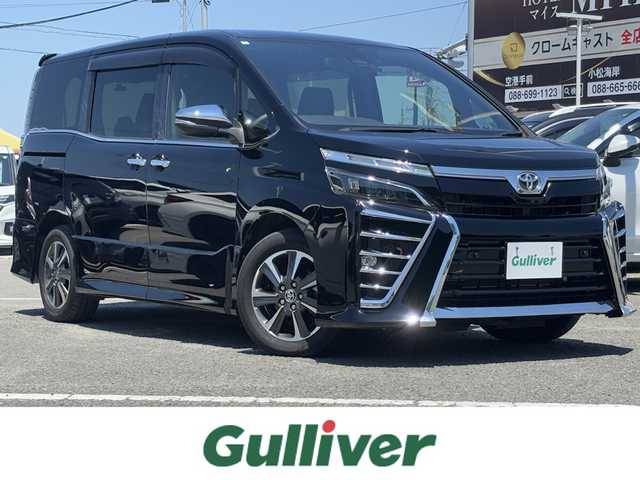 トヨタ ヴォクシー ZS 煌Ⅱ 徳島県 2020(令2)年 5万km ブラック ・ケンウッド９型ナビバックモニター/・カロッツェリアフリップダウンモニター/・両側パワースライドドア/・ＥＴＣ/・クルーズコントロール/・前後ドライブレコーダー/・後席エアコン/・フルセグテレビ/・衝突軽減ブレーキ/・純正フロアマット/・純正アルミホイール/・LEDヘッドライト/・フォグランプ/・クリアランスソナー/・オートハイビーム/・レーンアシスト/・スマートキー/・プッシュスタート