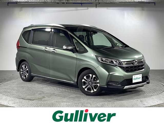 ホンダ フリード＋ ハイブリット クロスター ホンダセンシング 沖縄県 2020(令2)年 6.2万km シルバーミストグリーンM 県外仕入れ/禁煙車/ホンダセンシング/（衝突軽減ブレーキ/誤発進抑制機能/後方誤発進抑制機能/歩行者事故低減ステアリング/路外逸脱抑制機能/アダプティブクルーズコントロール/車線維持支援システム/先行車発進お知らせ機能/標識認識機能)/社外ナビ[MDV-D707BT]/（AM/FM/CD/DVD/BT//フルセグ）/バックカメラ/両側パワースライドドア/前後ドライブレコーダー/LEDオートライト/ハーフレザーシート/純正１５インチアルミホイール/純正フロアマット/スマートキー/ETC